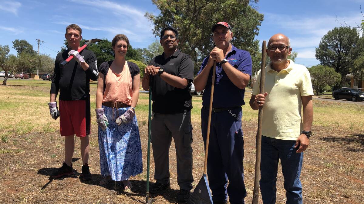 PUTTING DOWN ROOTS: Barnabas House resident Timothy Butler, caretaker Catherine Sharpe, site administrator Felix Sebastian, case worker Rick Andreatta and resident Meor Mohammad Shazilli all pose atop the site of the future garden. PHOTO: Monty Jacka