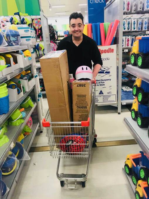 GIVING: Jason Owen buying some of the gifts he is set to hand out to Rural Aussie kids who have had a rough year. PHOTO: Supplied