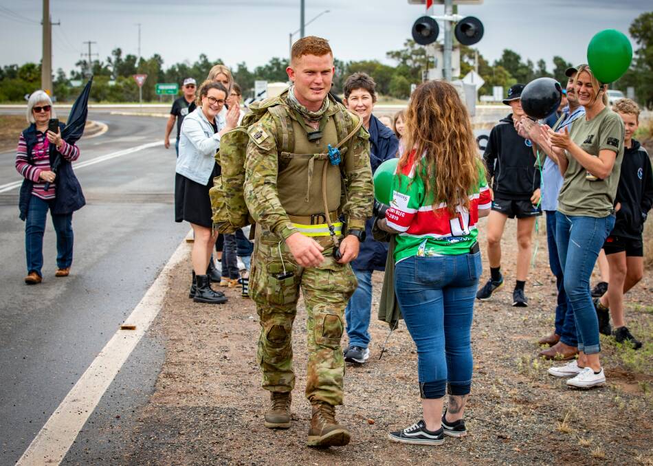WELCOME: More than 100 Goolgowi residents gathered outside the Royal Mail Hotel to cheer Brenton Byrne on as he completed his challenge. Picture: Andrew McLean Photography