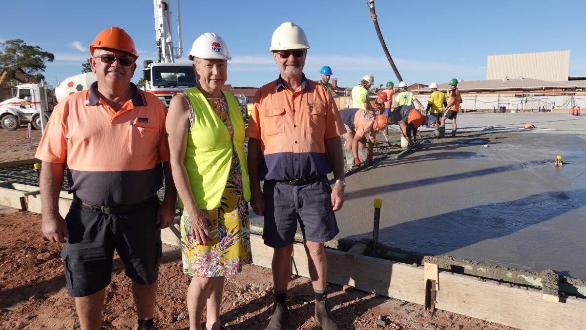 UNDERWAY: Marianne Warren (middle) with electrician Jim Curtis and engineer Jim Benton as concrete for the new building is poured. Mr Curtis and Mr Benton will both be working in the building once construction is complete. Photo: Monty Jacka