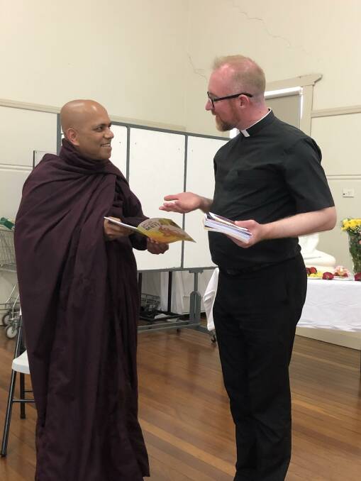 TWO WORLDS: The Venerable Kovida offers Dean Thomas Leslie a gift during the session. Photo: Kat Vella.