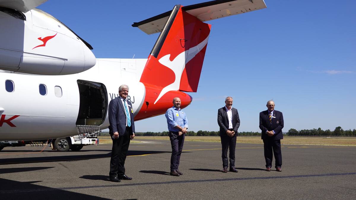 TOUCHDOWN: Griffith City Council's Brett Stonestreet and Simon Croce, QantasLink CEO John Gissing, and Griffith Mayor John Dal Broi alongside the first Qantas plan to fly the new route. Photo: Monty Jacka