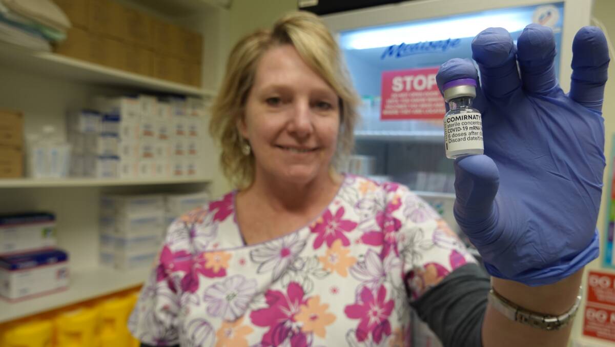 DOSES: Practice nurse Jacqui Mossman with a used vial of the Pfizer vaccine at the Griffith Vaccination Hub. PHOTO: Monty Jacka 