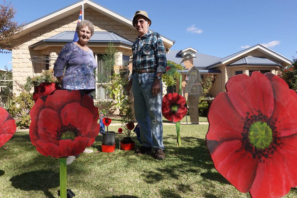 TRIBUTE: Diana and Angelo Dal Broi amonst the hand-crafted poppies they have set up in their front garden. PHOTO: Monty Jacka