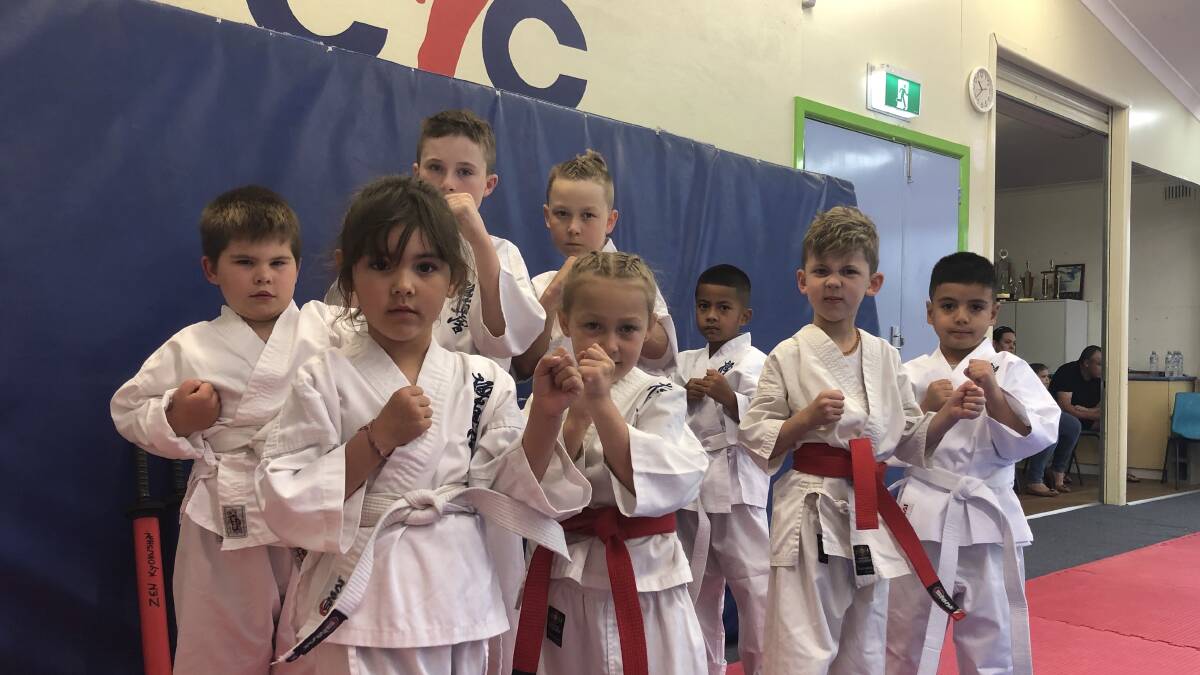 KARATE KIDS: Charlotte Cabera, Chloe Donovan, Vincent Cabera, and Dante Taufa intimidate the cameraman from the front row. While Jack Cadorin, Bray Power, Jayden Donovan, and Keni Fatafehi stand strong in the back row. PHOTO: Monty Jacka