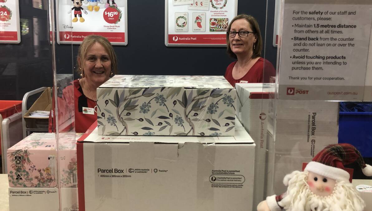 PRESENT GALORE: Griffith Post Office's Donna Snaidero and Julie Croce with just a very small percentage of the parcels going through the post office this holiday season. PHOTO: Monty Jacka