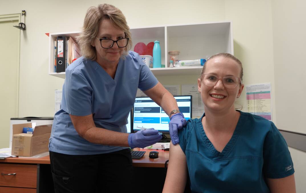 PROTECTED: Jacqui Mossman administers the Astra Zeneca COVID vaccine to Sarah Jay at the Griffith Vaccination Hub. Photo: Monty Jacka.