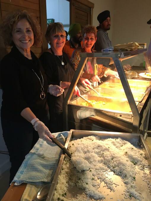 GOOD ATMOSPHERE: Rina Mercuri, Rhonda Jobbitt and Michele O'Keefe helping serve the food at the fifth-annual Curry and Jam. PHOTO: Supplied