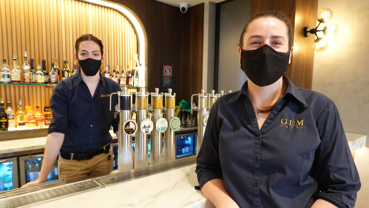 PRECAUTION: The Gem Hotel's Lilly Bordignon and Celinea Reedy have been wearing masks while working at the venue following the announcement of new rules. PHOTO: Monty Jacka