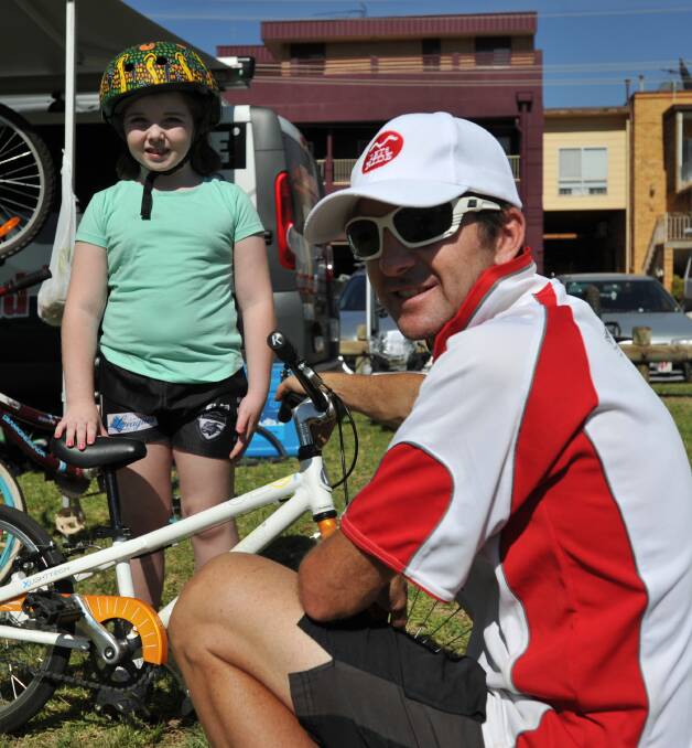 RIDE: Eight-year-old Emily Campbell gets a maintenance lesson from Damien Enderby at the Cycling Australia Aboriginal Bicycle Safety Program. Picture: Stephen Mudd.