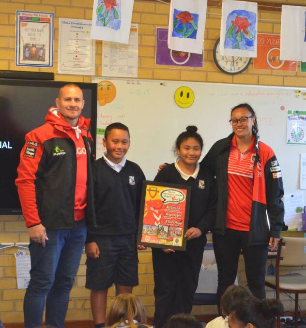 LINKING UP: Griffith Public students Sioeli Vea and Nancy Tietie (centre) receive a gift from St. George's Matt Cooper and Takilele Katoa on Tuesday. PHOTO: Calhan Behrendt