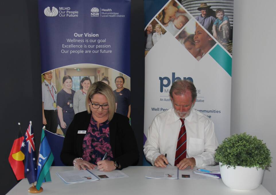 PLANNING AHEAD: MPHN CEO Melissa Neal and MLHD Acting Chief Executive Maurice Ahern sign the Murrumbidgee Maternal and Child Health Strategy. PHOTO: Supplied