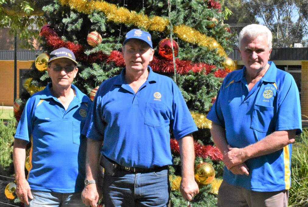 GETTING IN THE SPIRIT: Rotary Club of Griffith secretary Peter Little, community officer Paul Condon and president Peter Dart prepare to kick off the Christmas Carnival in Memorial Park. PHOTO: Calhan Behrendt