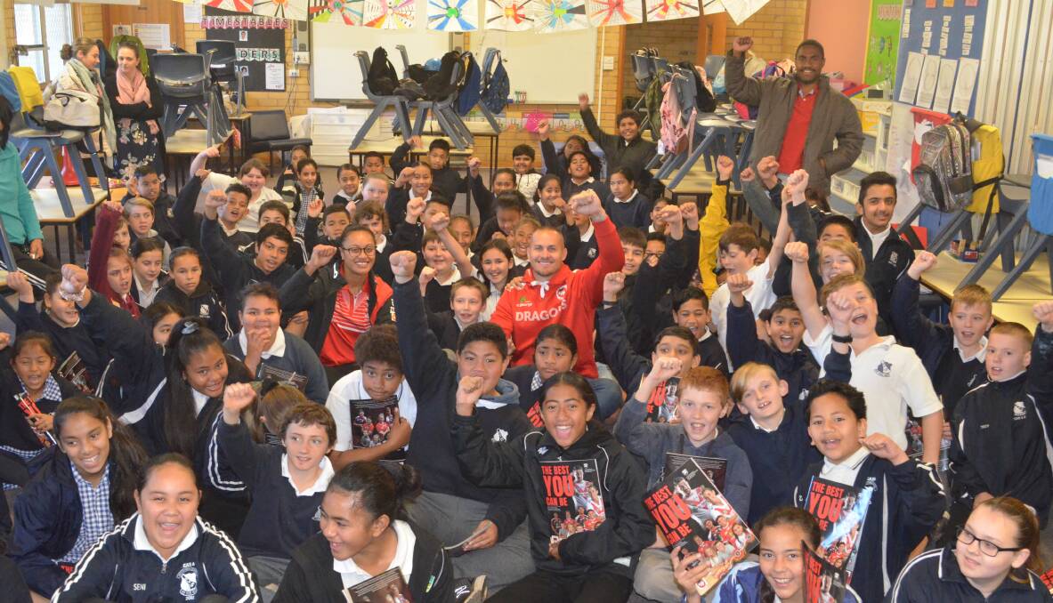 ROARING FUN: Dragons ambassadors Takilele Katoa and Matt Cooper visit Griffith Public School's Stage 3 classes on Tuesday. PHOTO: Calhan Behrendt