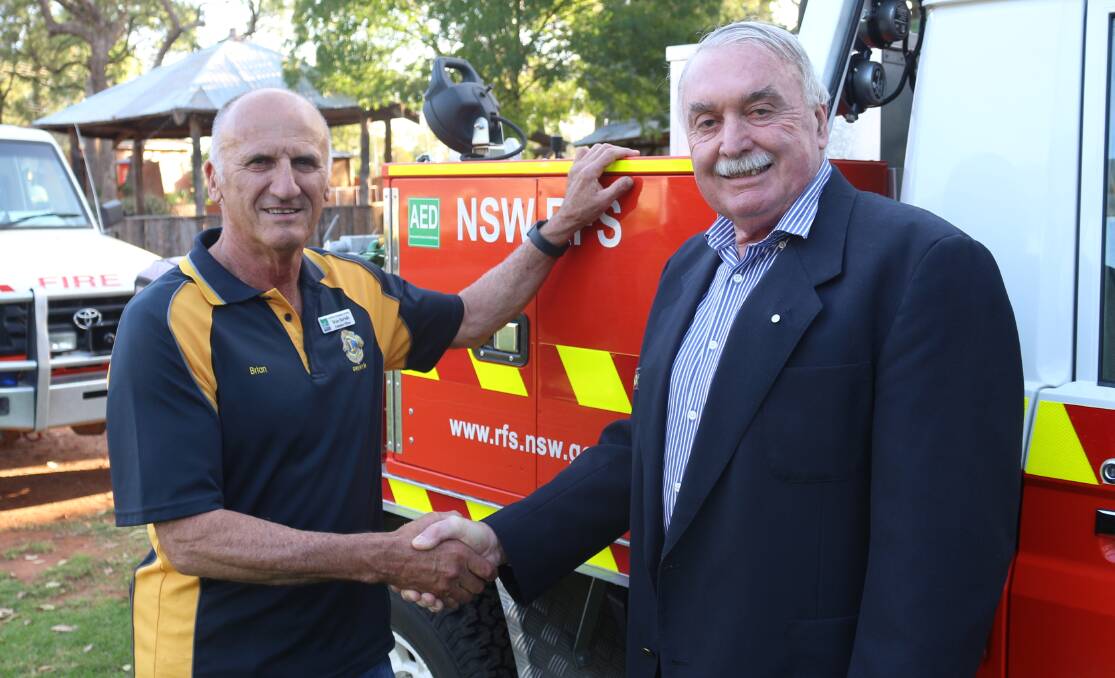 VALIANT EFFORTS THANKED: Lions Club of Griffith president Brian Bortolin gives thanks to RFS Group Captain Colin Smeeth for the efforts of MIA firefighters during this bushfire season. PHOTO: Calhan Behrendt