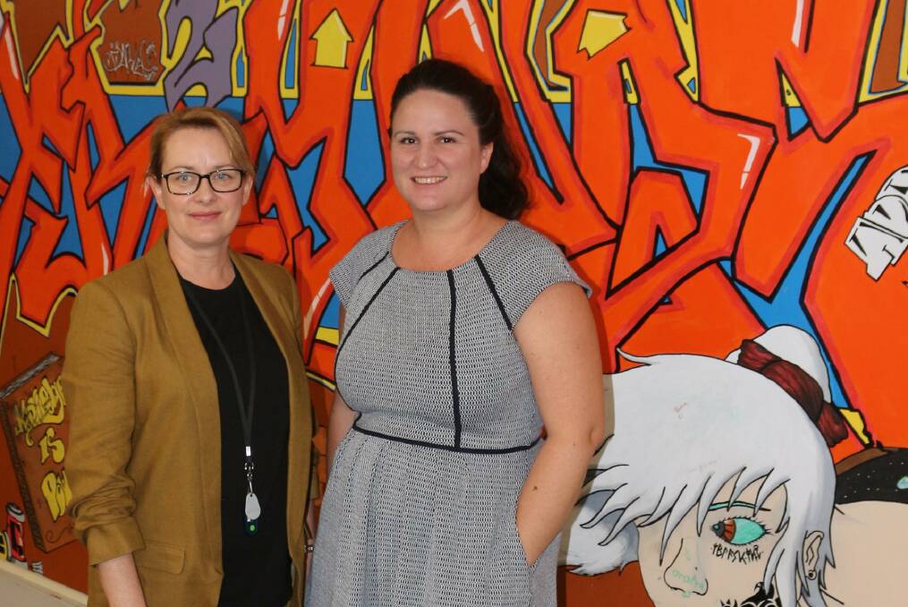 NEW COAT OF PAINT: Griffith City Library manager Shiron Kirkman and Banna Lane Festival manager Carrah Lymer are on the hunt for a new artist to give new life to an outdated wall in the city's library. PHOTO: Calhan Behrendt