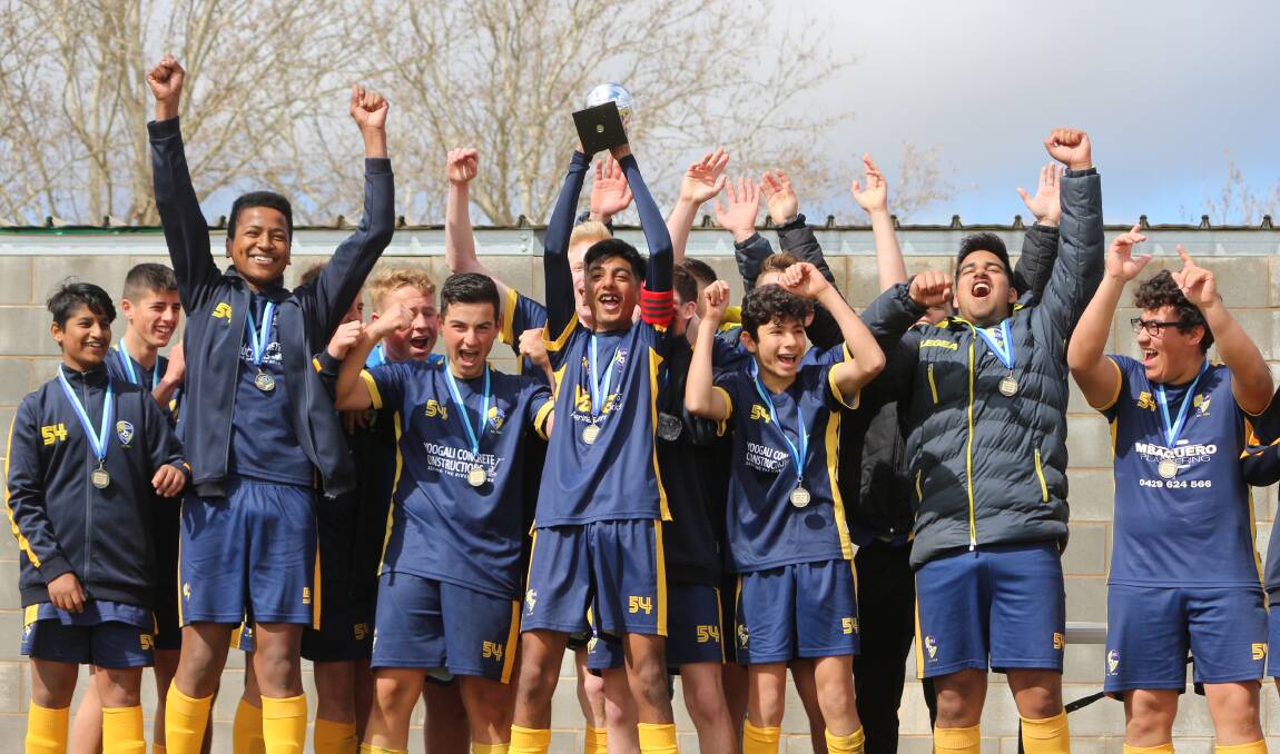 GLORIOUS GOLDEN GOAL: The Yoogali SC under 16s side celebrate after claiming a dramatic 1-0 golden goal win against Yenda Tigers in the grand final. PHOTO: Calhan Behrendt