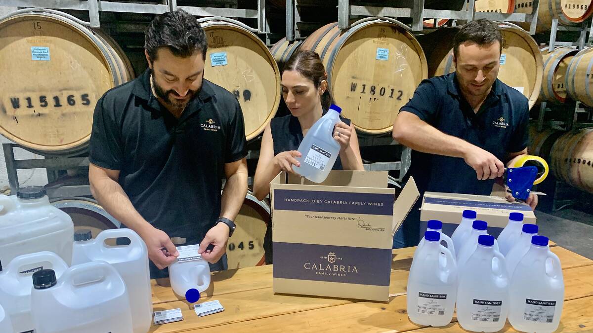 PACKING: Michael Calabria, Elizabeth Calabria-Staltare and Andrew Calabria work to package hand sanitiser produced by the winery to go out to health services. PHOTO: Supplied