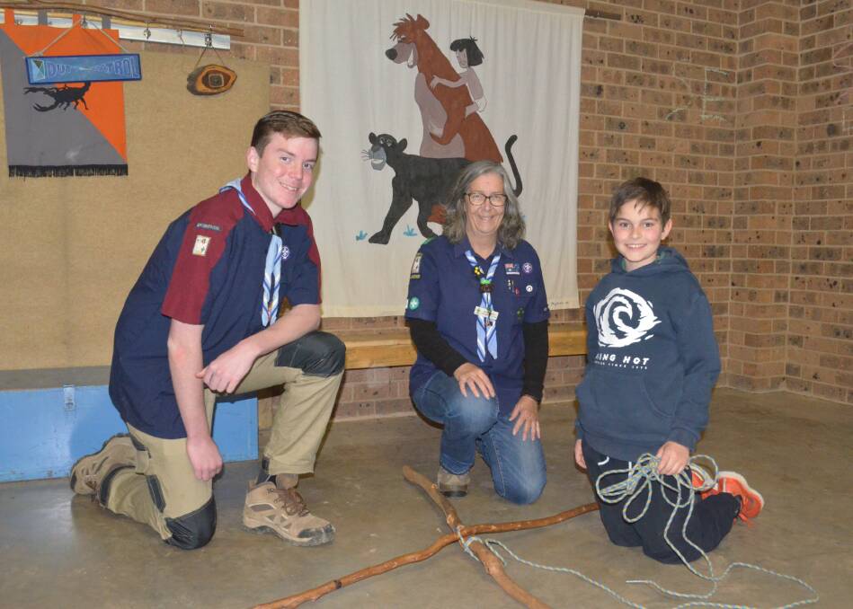HELPING HAND: 2nd Griffith Scout Group leader Silvia Shaw (middle) helps Venturer Scout member Cooper Angel (left) and Scout member Finn Piccoli (right) work on knot tying during their Scout meeting on Tuesday. PHOTO: Calhan Behrendt