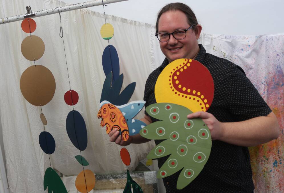 PAINTING PATTERNS: Griffith Regional Art Gallery coordinator Raymond Wholohan with some of the designs made by community members during sessions held at the gallery. PHOTO: Calhan Behrendt