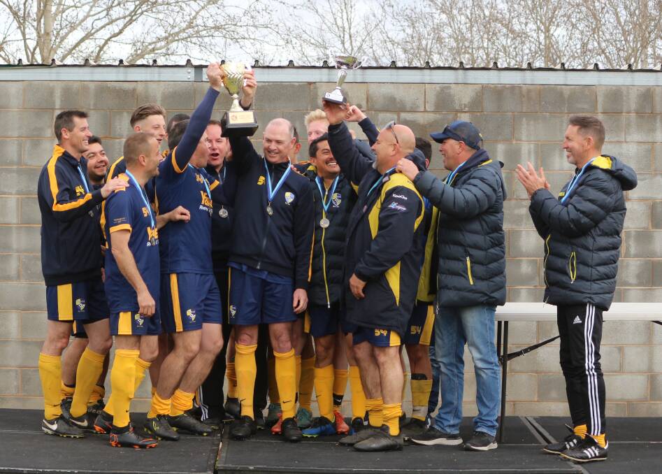 CLOSE ENCOUNTER: Yoogali SC's Reserve Grade side celebrates after claiming the championship with a 4-3 win over Deniliquin Wanderers on Sunday. PHOTO: Calhan Behrendt