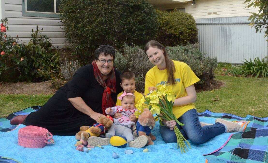 BLOOMING IN YELLOW: Mary Fuller, Jobe and Elisia Catanzariti and Linda Hoey get ready for Friday's Daffodil Day appeal, which aims to raise funds for cancer research. PHOTO: Calhan Behrendt