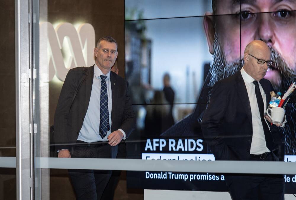 RAIDS: Executive editor John Lyons leads the AFP out of the ABC's Sydney headquarters in May this year. Picture: Wolter Peeters