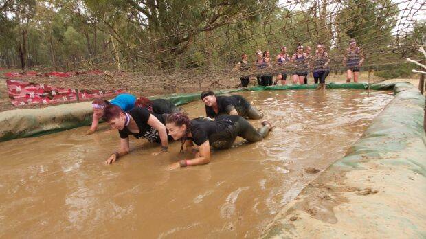 TESTED ON COURSE: Participants at previous Miss Muddy events show their skills and fitness. Picture: Canberra Times