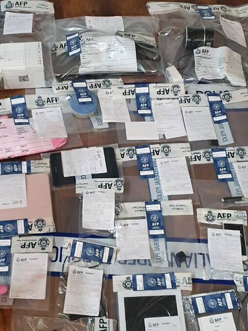EVIDENCE: Australian Federal Police seized multiple phones, tablets, cameras and hard drives from three Riverina homes and cars on Wednesday. Picture: AFP