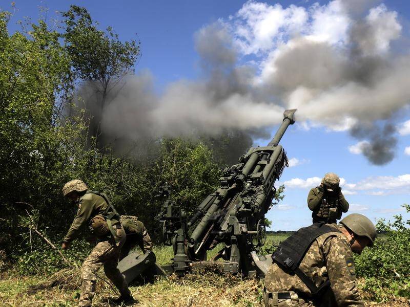 Ukrainian servicemen fire an M777 howitzer at a Russian frontline in the Donetsk region.