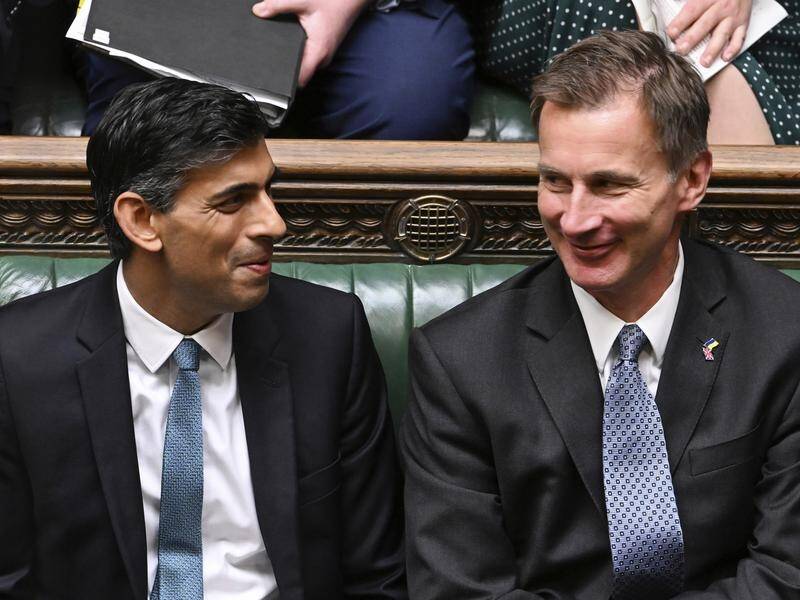 Rishi Sunak (left) and Jeremy Hunt are trying to prepare their Conservative Party for tax increases. (AP PHOTO)