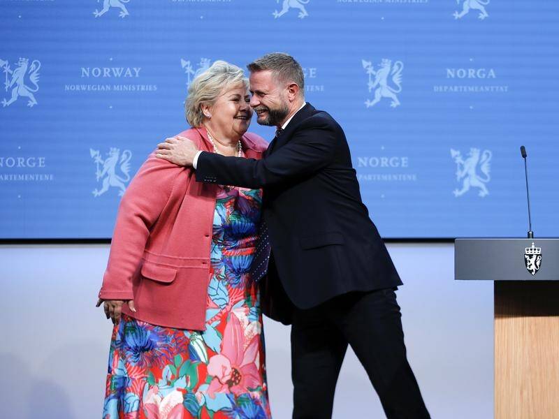 Norwegian Health Minister Bent Hoie (right) says "handshakes will again be allowed".