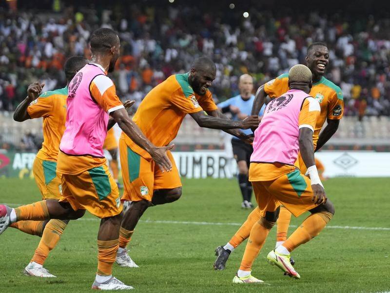 Ivory Coast's Nicolas Pepe (R) celebrates after scoring against Algeria at Douala's Japoma Stadium.