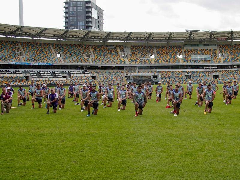 The Brisbane took Lions a knee at the Gabba in a show of support for the club's indigenous players.
