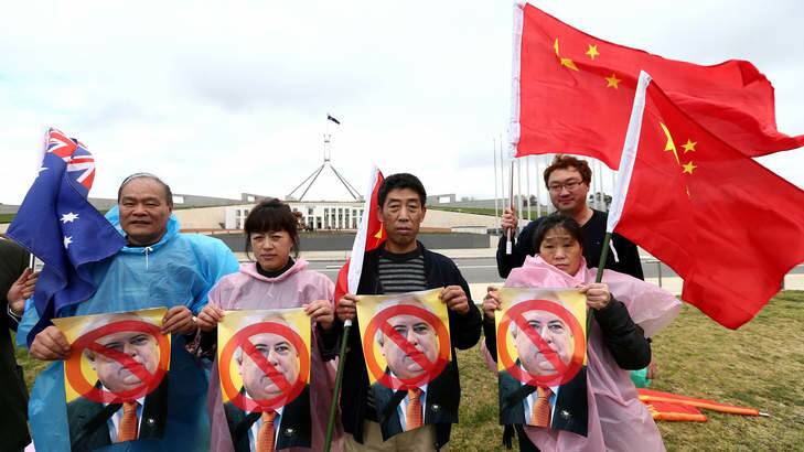 Members of the Chinese community protesting against Palmer United Party leader Clive Palmer. Photo: Alex Ellinghausen