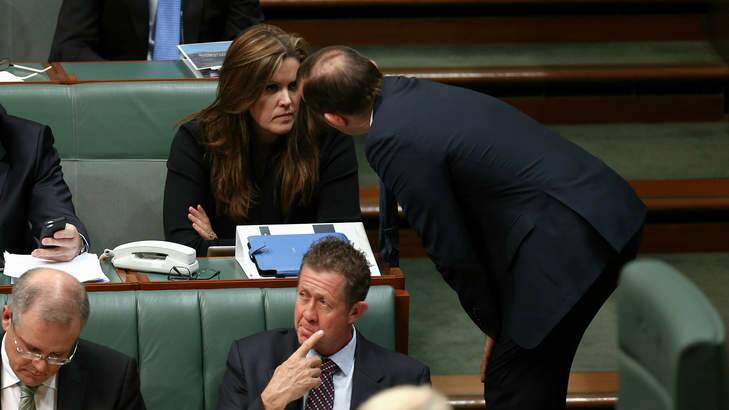 Prime Minister Tony Abbott in discussion with his chief of staff Peta Credlin during question time. Photo: Alex Ellinghausen