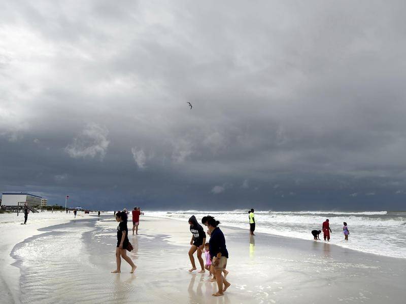 Lifeguards posted red flags at several Gulf Coast beaches, where swimming and wading were banned.