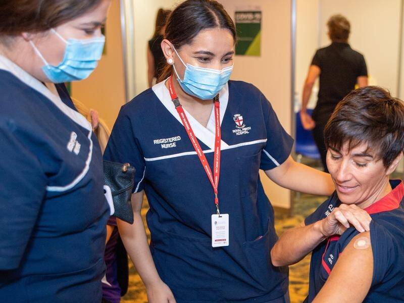 Nurse Antonia Garza (right) was among frontline workers to receive the Pfizer vaccine jab in Perth.
