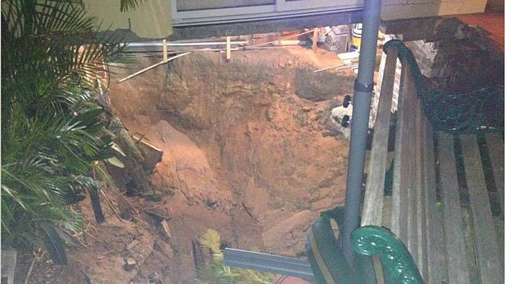A couple's three-storey home was swallowed by a sinkhole in Swansea. Photo: Supplied