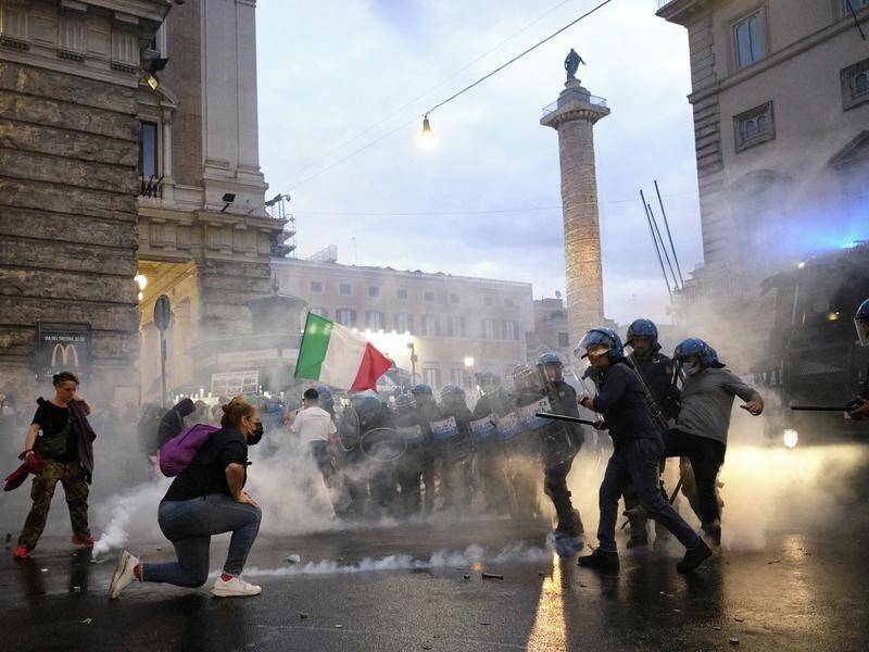 Demonstrators and police clash during protests in Rome against COVID-19 restrictions.