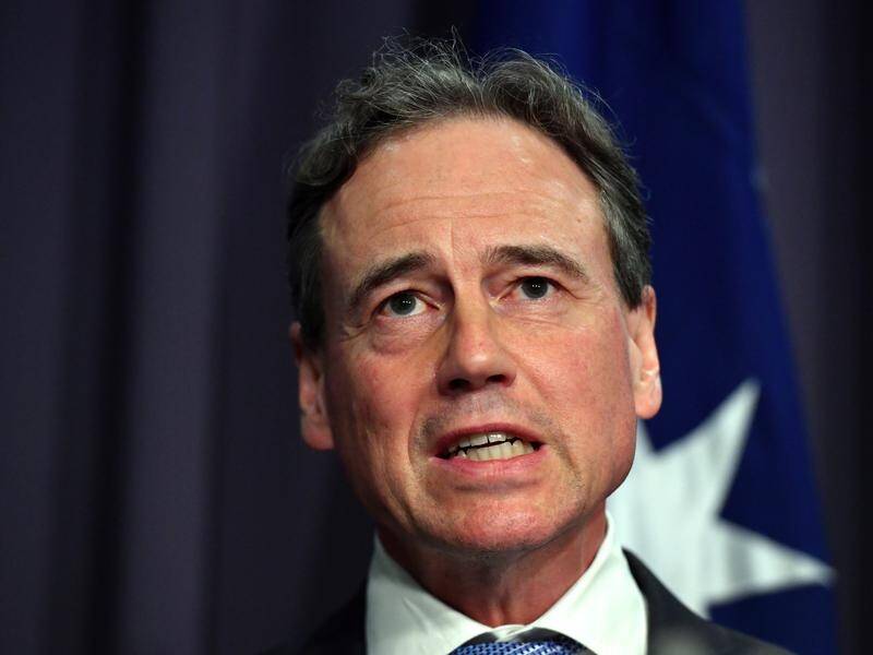 Greg Hunt has defended the government's vaccine rollout after revelations about talks with Pfizer.