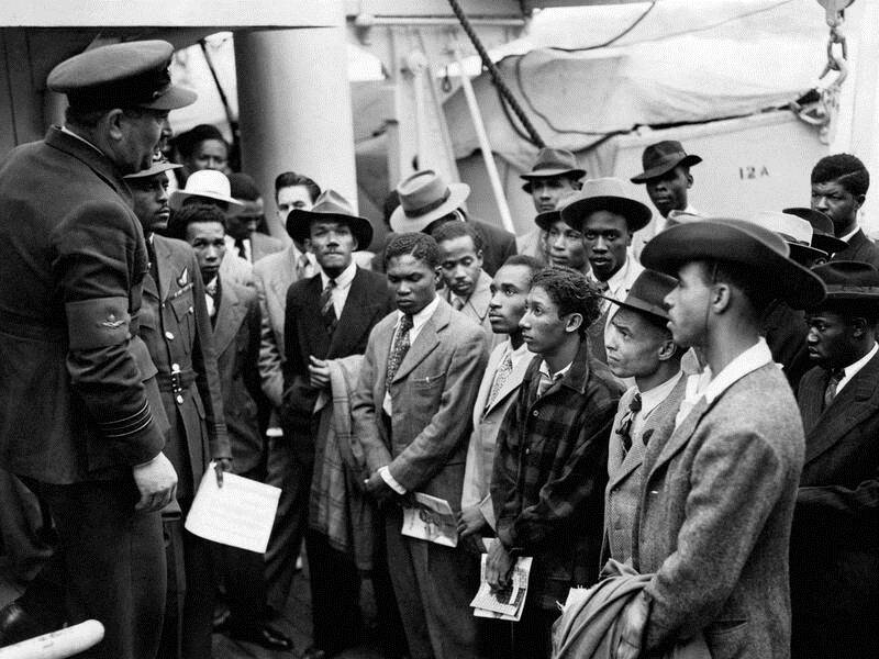 Jamaican immigrants off the ex-troopship HMT 'Empire Windrush' are welcomed to the UK in 1948.