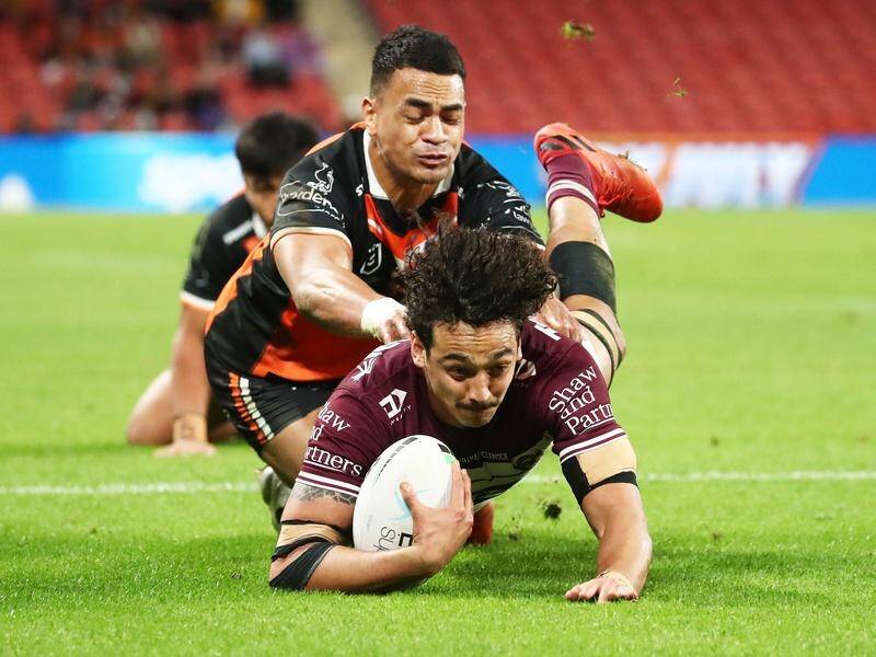 Manly's Morgan Harper scores one of his three tries as the Eagles downed Wests Tigers.