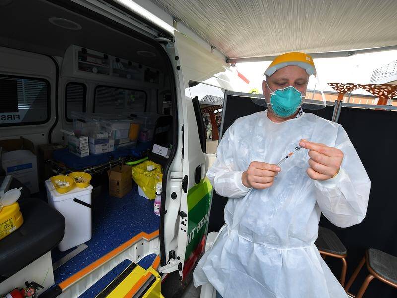 A healthcare worker gets prepared at a pop-up COVID-19 vaccination van in Melbourne.