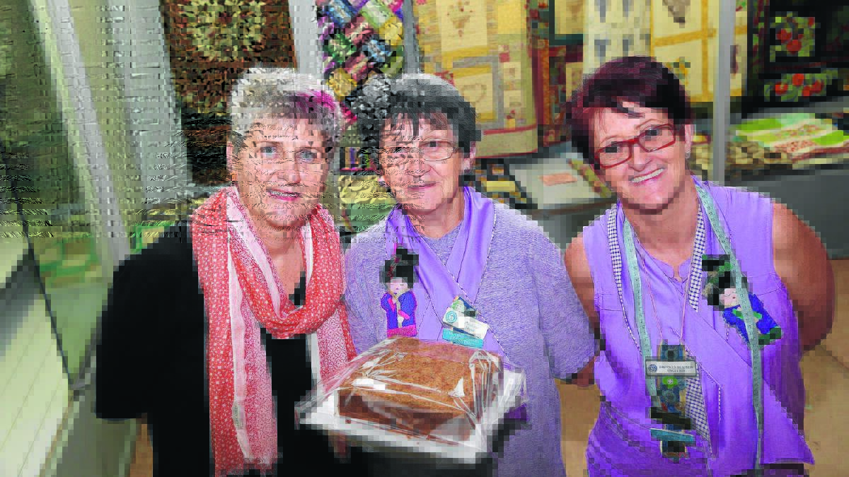 READY TO GO: CWA state president Tanya Cameron, CWA Land and Cookery secretary Pauline Hunt and Land and Cookery chairperson Bronwyn Dunston put finishing touches on displays yesterday ahead of a busy week in Griffith. Picture: Anthony Stipo 