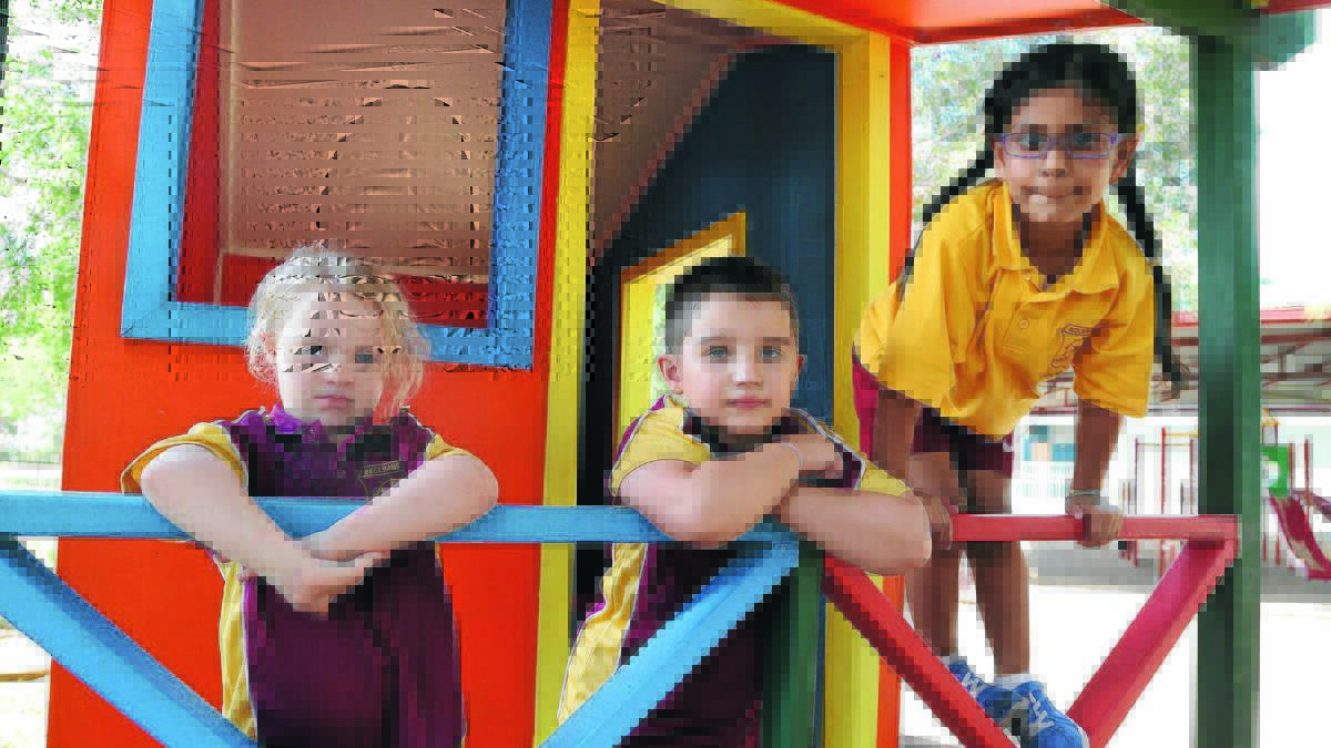 READY, WILLING AND ABLE: Beelbangera Public School kindergarten students Molly Serafin, Tyler Smith and Samrit Grewal have settled in well despite their disabilities. Picture: Anthony Stipo