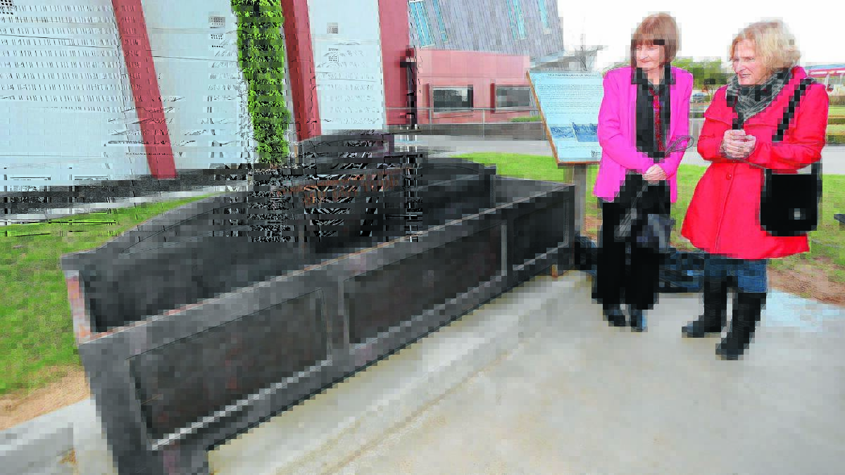 FITTING TRIBUTE: Carol Dedman and her sister Pam Burns admire the new iron water trough. 
