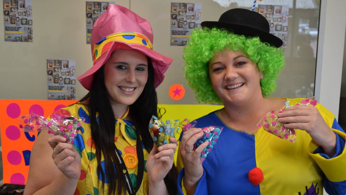 CARING CLOWNS: Bank customers were surprised when Fiona Grehan and Sian Cutter greeted them in costume on Friday morning. 