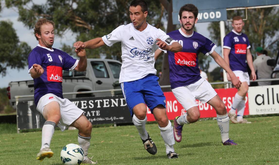 CRUNCH TIME: HFC captain-coach Anthony Agresta, pictured here in the thick of the club's 2-0 trial match win over Melrose earlier this month, is looking forward to this weekend's Real Juice Cup.