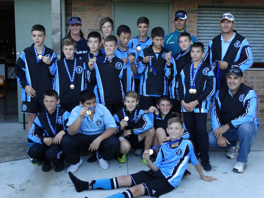 WINNERS ARE GRINNERS: Griffith's under 13s celebrate their Country Cup success in Broulee.